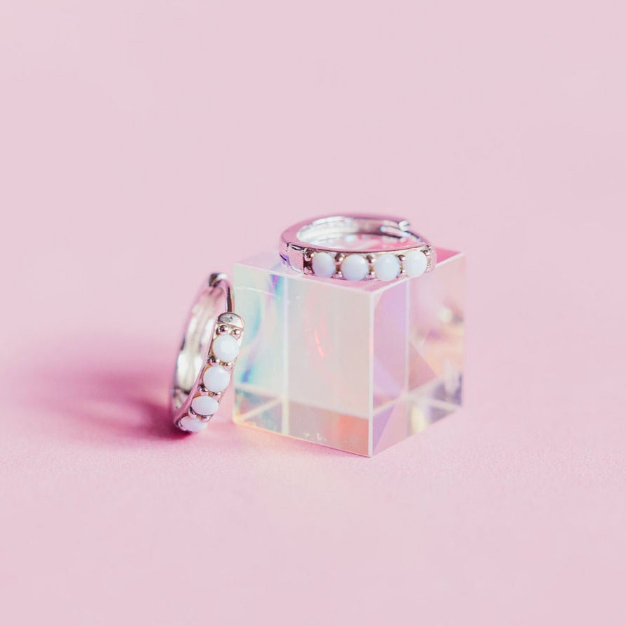 Chloe + Lois White Opal Huggie Hoops in Sterling Silver